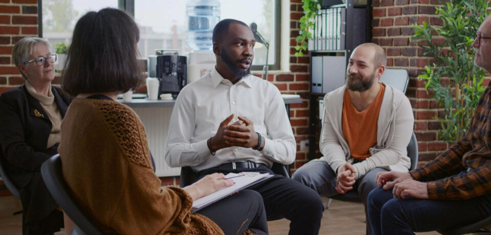 african-american-man-sharing-addiction-story-with-group-people-aa-therapy-meeting-adult-having-conversation-with-psychologist-patients-circle-rehabilitation-session_482257-30588_result